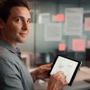 Financial technology executive in a Hartford office reviewing signed agreements on a tablet